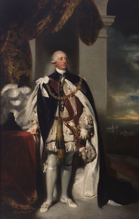 Painting. A pale-skinned, clean-shaven with a long face and drooping lips stands in front of a stone column and looks off to our right. He wears a heavy, white-lined black robe over a shimmering ivory-white suit.